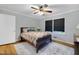 Cozy main bedroom with hardwood flooring, decorative rug and two bright windows at 827 Union St, Cary, NC 27511