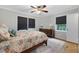 Cozy main bedroom with hardwood flooring, decorative rug and two bright windows at 827 Union St, Cary, NC 27511