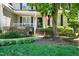 Charming front porch featuring decorative lanterns, lush landscaping, and a welcoming entrance to the home at 8712 Walkelin Ct, Raleigh, NC 27615