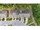 Aerial view of neighborhood townhomes surrounded by dense green trees and landscaping at 927 Contessa Dr, Cary, NC 27513