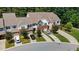 Bird's-eye view of townhomes with garages and private driveways in a green, wooded area at 927 Contessa Dr, Cary, NC 27513