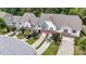 Aerial shot of townhomes surrounded by mature trees and well manicured landscaping at 927 Contessa Dr, Cary, NC 27513