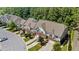 Aerial perspective of townhome roofs, driveways, and surrounding foliage in a neighborhood at 927 Contessa Dr, Cary, NC 27513