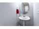 Powder room with pedestal sink and modern fixtures at 927 Contessa Dr, Cary, NC 27513