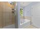 Modern bathroom with glass-enclosed shower and soaking tub at 927 Contessa Dr, Cary, NC 27513