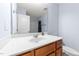 A vanity with a single sink and wood cabinets in a well lit bathroom at 927 Contessa Dr, Cary, NC 27513