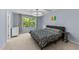 Bright bedroom showcasing a comfortable bed, large window with natural light, and stylish chandelier at 927 Contessa Dr, Cary, NC 27513