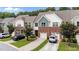 Inviting townhomes showcase a mix of brick and siding, complemented by mature trees at 927 Contessa Dr, Cary, NC 27513