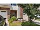 Detailed shot of townhome exterior with a garage, small garden, and covered entry at 927 Contessa Dr, Cary, NC 27513