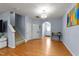 Inviting foyer featuring gleaming wood floors, a stylish chandelier, and stairway access to the upper level at 927 Contessa Dr, Cary, NC 27513
