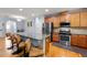 Stylish kitchen featuring stainless steel appliances, an island with bar seating, and hardwood flooring at 927 Contessa Dr, Cary, NC 27513