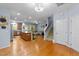 Open-concept living area boasts wood floors, an island and staircase leading to the second floor at 927 Contessa Dr, Cary, NC 27513