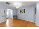 Open concept living room with hardwood floors and neutral paint at 927 Contessa Dr, Cary, NC 27513