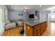 Bright open living space featuring kitchen with bar seating, living room, and an open floor plan at 927 Contessa Dr, Cary, NC 27513