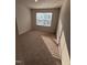 A sunlit bedroom includes a window with blinds and soft carpeting at 0416 Hazy Hls Ln, Garner, NC 27529