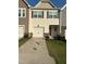 Charming townhome featuring a one-car garage and stone accents at 0416 Hazy Hls Ln, Garner, NC 27529