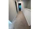 Upstairs hallway featuring neutral carpet and access to bedrooms and bathrooms at 0416 Hazy Hls Ln, Garner, NC 27529