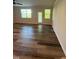 Bright living room with luxury vinyl plank flooring and access to the backyard at 0416 Hazy Hls Ln, Garner, NC 27529
