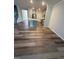 Open-concept living area with luxury vinyl plank flooring and neutral paint at 0416 Hazy Hls Ln, Garner, NC 27529
