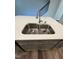 Double sink on an island with white countertops and gray cabinets at 0416 Hazy Hls Ln, Garner, NC 27529