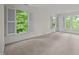 This bedroom features neutral carpet and three shuttered windows at 100 Edenburgh Rd # 202, Raleigh, NC 27608