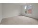 This cozy carpeted bedroom features a large window at 100 Edenburgh Rd # 202, Raleigh, NC 27608