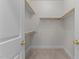 This is a spacious walk-in closet with white shelving and carpet at 100 Edenburgh Rd # 202, Raleigh, NC 27608