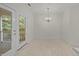 Dining area featuring tile floor and access to balcony at 100 Edenburgh Rd # 202, Raleigh, NC 27608