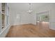 Dining area with large windows and hardwood floors, illuminated by a chandelier at 100 Edenburgh Rd # 202, Raleigh, NC 27608