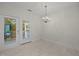 Bright dining area with chandelier and access to balcony at 100 Edenburgh Rd # 202, Raleigh, NC 27608