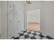 Elegant entryway featuring black and white tiled floor and access to the living room with pristine hardwood floors at 100 Edenburgh Rd # 202, Raleigh, NC 27608