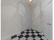 Welcoming entryway with black and white tiled floor, complemented by white walls and a stylish chandelier at 100 Edenburgh Rd # 202, Raleigh, NC 27608