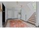 Well-lit hallway featuring tiled floors, staircase, and unit entrances, creating a welcoming and functional space at 100 Edenburgh Rd # 202, Raleigh, NC 27608