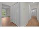 Hallway featuring hardwood floors, closets, and access to various rooms at 100 Edenburgh Rd # 202, Raleigh, NC 27608