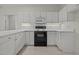 This is a kitchen featuring a stove and white cabinets and countertops at 100 Edenburgh Rd # 202, Raleigh, NC 27608