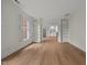 Bright living room with hardwood floors, large windows, and built-in shelving at 100 Edenburgh Rd # 202, Raleigh, NC 27608