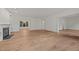 Open living room featuring a fireplace, hardwood floors, and large windows at 100 Edenburgh Rd # 202, Raleigh, NC 27608