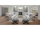 Staged living room with hardwood floors, white sofas, fireplace, and built-in bookshelves for sophisticated living at 100 Edenburgh Rd # 202, Raleigh, NC 27608