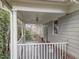 View of covered porch with white railing and ceiling fan at 100 Edenburgh Rd # 202, Raleigh, NC 27608