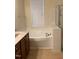Bright bathroom with a luxurious soaking tub and a separate shower at 108 Bally Shannon Way, Apex, NC 27539
