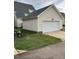 Detached two-car garage with siding and driveway, nestled in a landscaped yard at 108 Bally Shannon Way, Apex, NC 27539