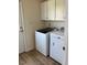 Convenient laundry room equipped with a washer, dryer, and storage cabinets at 108 Bally Shannon Way, Apex, NC 27539