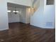 Open-concept living room with hardwood floors, chandelier, and wainscoting at 108 Bally Shannon Way, Apex, NC 27539