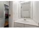 Clean half bathroom with a white vanity and framed mirror at 110 Great Ridge Ct, Morrisville, NC 27560
