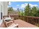 Inviting wooden deck with outdoor seating, overlooking lush trees and blue skies at 110 Great Ridge Ct, Morrisville, NC 27560