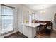 Bright dining area featuring wood floors, access to the kitchen, and backyard patio at 110 Great Ridge Ct, Morrisville, NC 27560