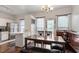 Cozy dining area with natural light, wood floors, and access to the kitchen and backyard at 110 Great Ridge Ct, Morrisville, NC 27560