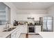 Bright kitchen with white cabinets, stainless steel appliances, and modern countertops at 110 Great Ridge Ct, Morrisville, NC 27560