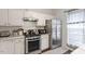 Well-equipped kitchen featuring stainless steel appliances, white cabinets, and ample counter space at 110 Great Ridge Ct, Morrisville, NC 27560