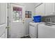 Bright laundry room with new washer and dryer, storage cabinets, and convenient access to the outside at 110 Great Ridge Ct, Morrisville, NC 27560